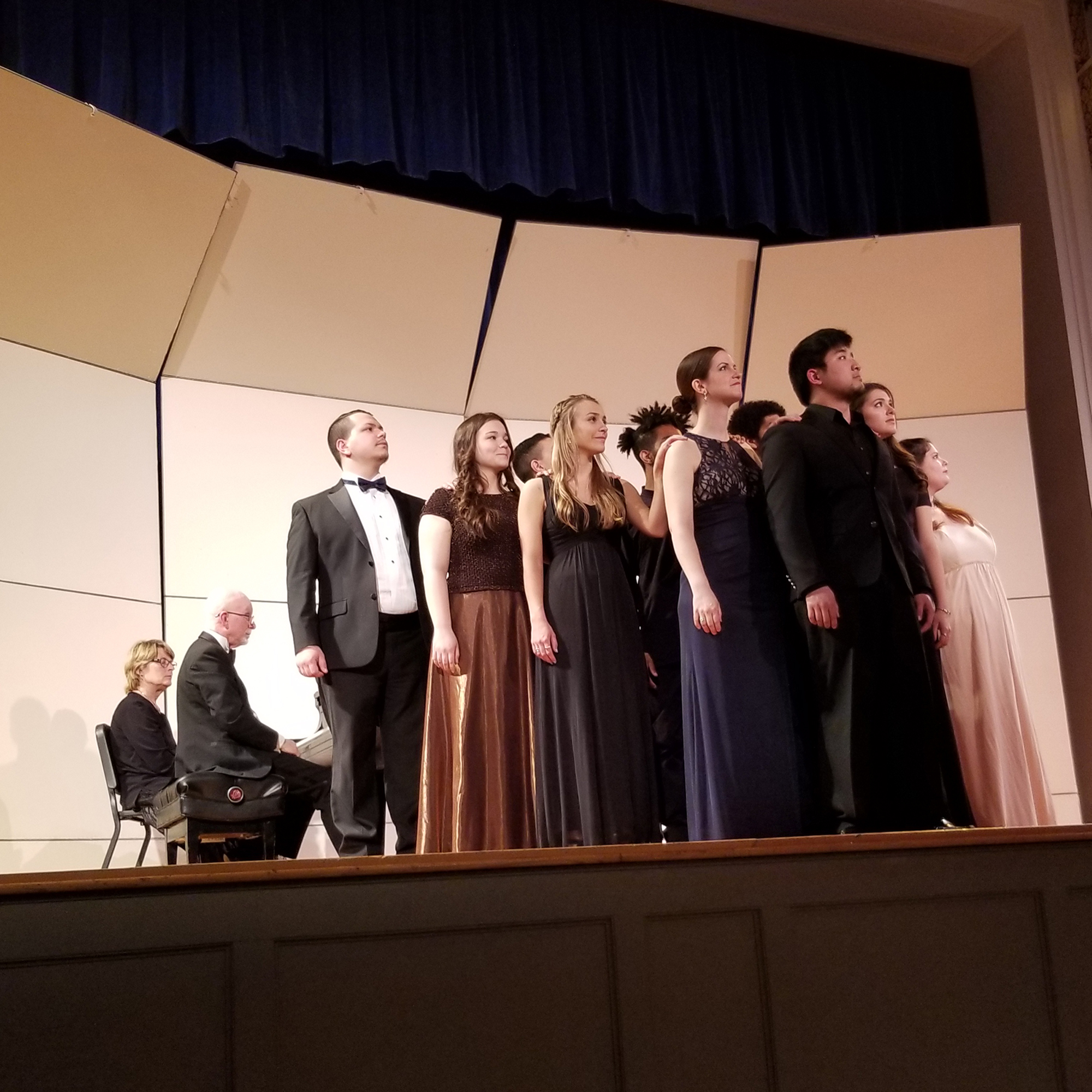 Students sining on stage